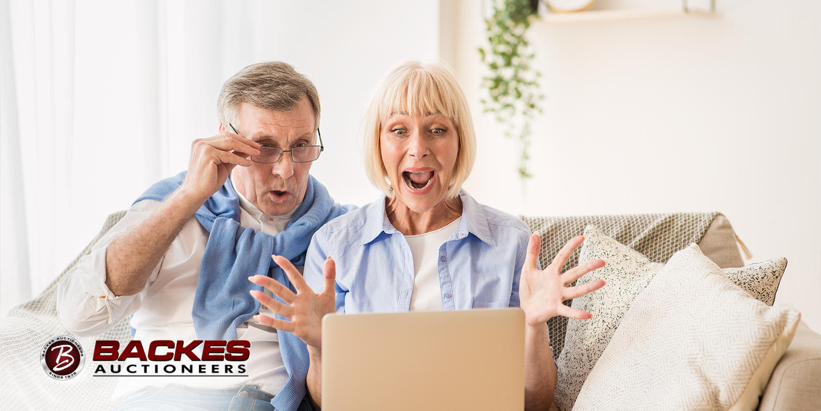 Image for Image of older man and woman sitting on the couch looking at a laptop screen in excitement